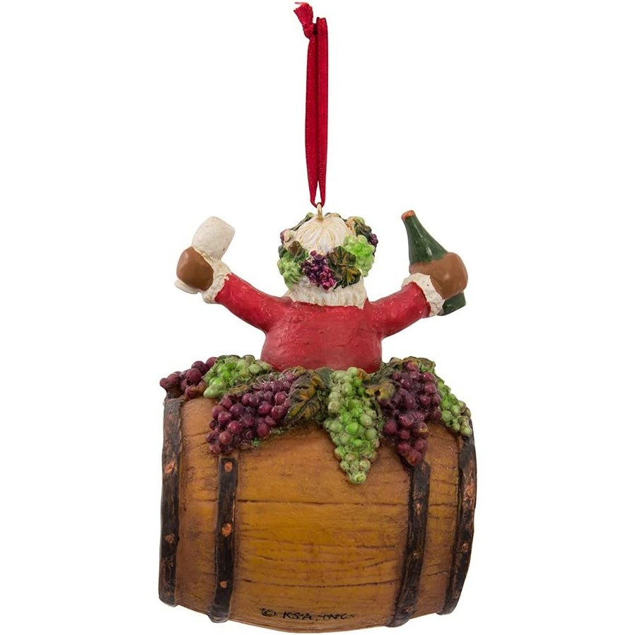 A back view of a Christmas tree ornament which features Santa on a wine barrel while holding a wine bottle and glass.