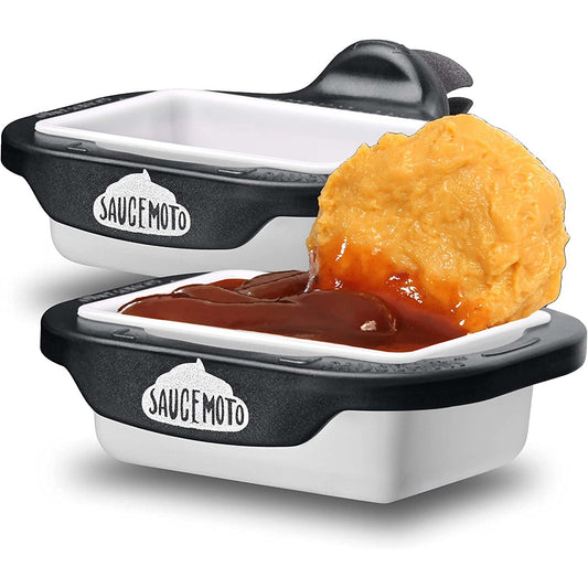 Two in car sauce holders to hold your dipping sauces. One of the holders is filled with sauce and a chicken nugget.