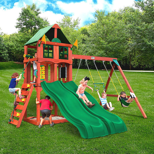 a wooden children's outdoor play set complete with swings, slides and a rock climbing wall.