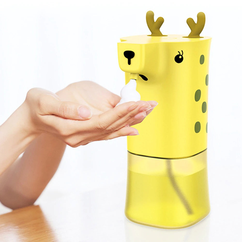 A kids soap dispenser which looks like a cartoon giraffe. Foam soap is being dispensed from the nozzle into the palm of a persons hand showing the dispenser being used.