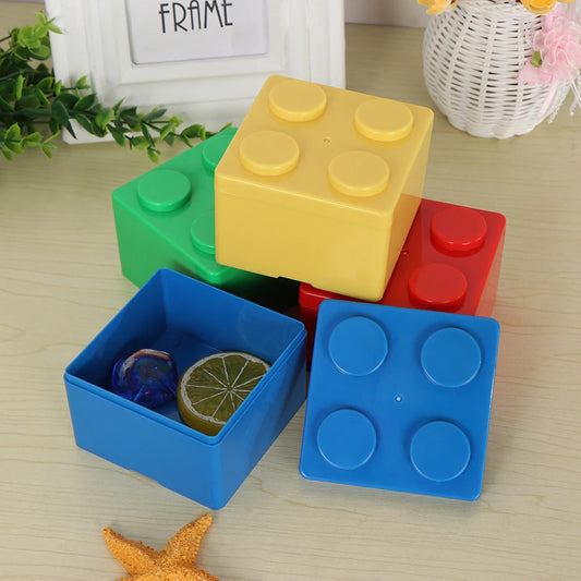 Giant sized versions of Lego pieces which are storage boxes. They are square shaped and are blue, red, yellow and green.