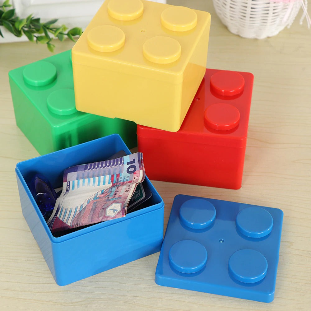 Four square storage boxes which look like super-sized Lego pieces in various colors. One storage box is open and filled with foreign money.