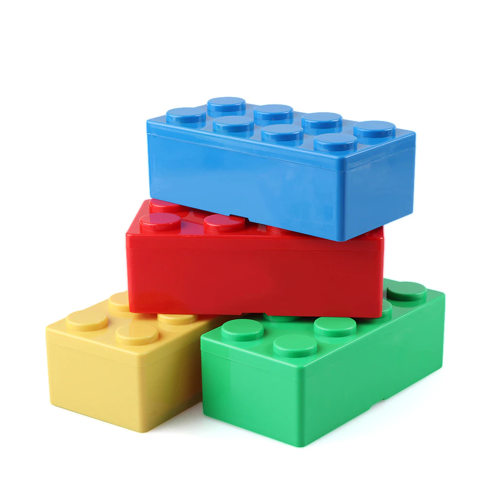 Four rectangular storage boxes which look like giant Lego pieces. They are yellow, green, red and blue. The red and blue Lego storage blocks are stacked on top of the green and yellow ones.
