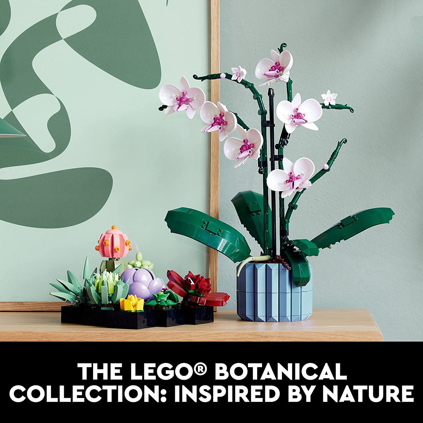 A Lego succulents building kit for adults on a table next to an orchid which is also built from Lego.