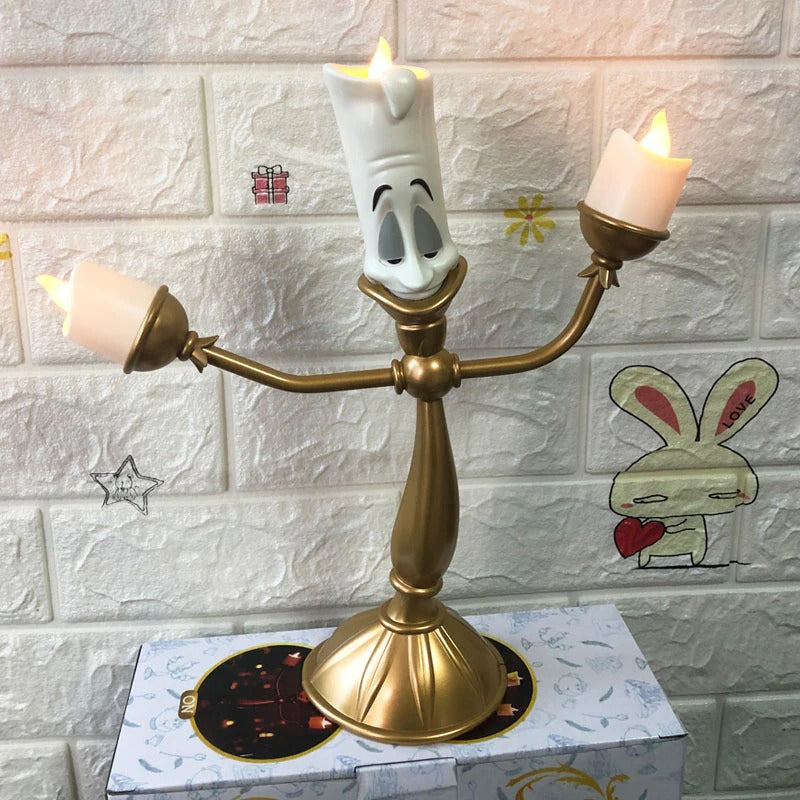 A candlestick which looks like Lumiere from Beauty and the Beast. He is holding two candles and one sits on his head.