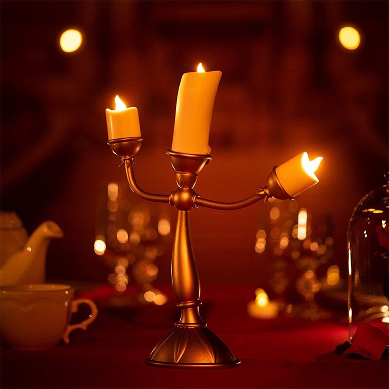 A back view of a candlestick which looks like Lumiere from Beauty and the Beast. He is holding LED candles and has one on his head.