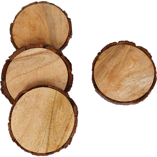 Four wooden drink coasters with a dark edge of bark on the outside.