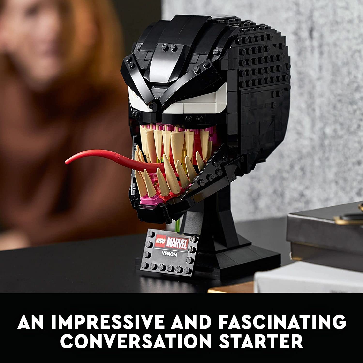 A completed version of Venom built from Lego which also includes a plaque which says, Lego Marvel Venom. There is text which reads, "An impressive fascinating conversation starter."