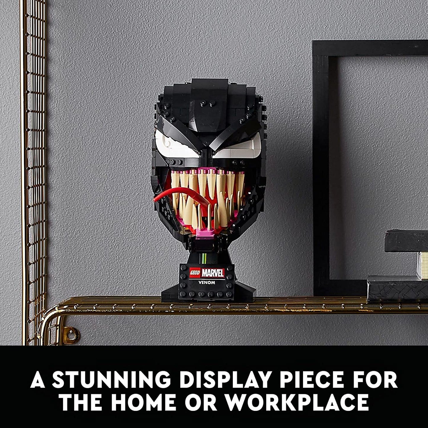 A fully complete model of Venom made from Lego sitting on a metal table. There is text which reads, "A stunning display piece for the home or workplace."
