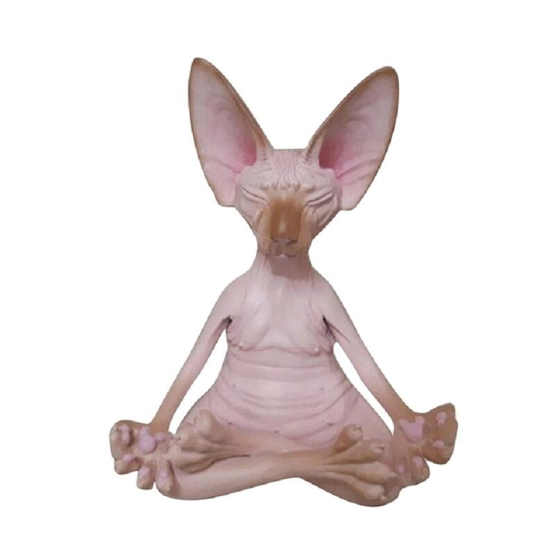 A solitary meditating Sphynx toy cat sitting in a yoga pose with its legs crossed and fingers pinched as if it is meditating. The cat is colored pink with brown tips.