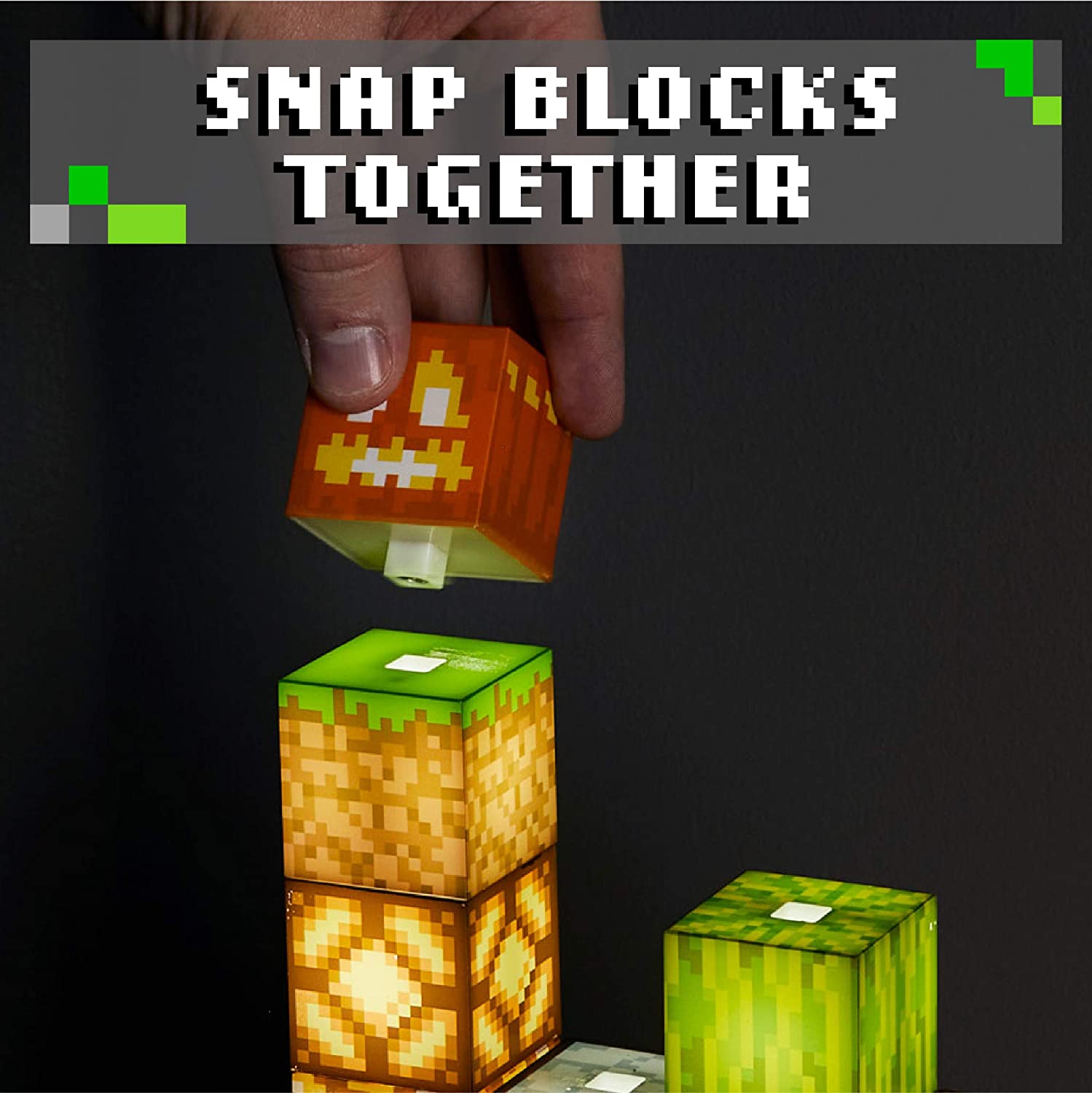 A hand is adding a block to the top of a Minecraft block building light. The text reads, 'Snap blocks together.'