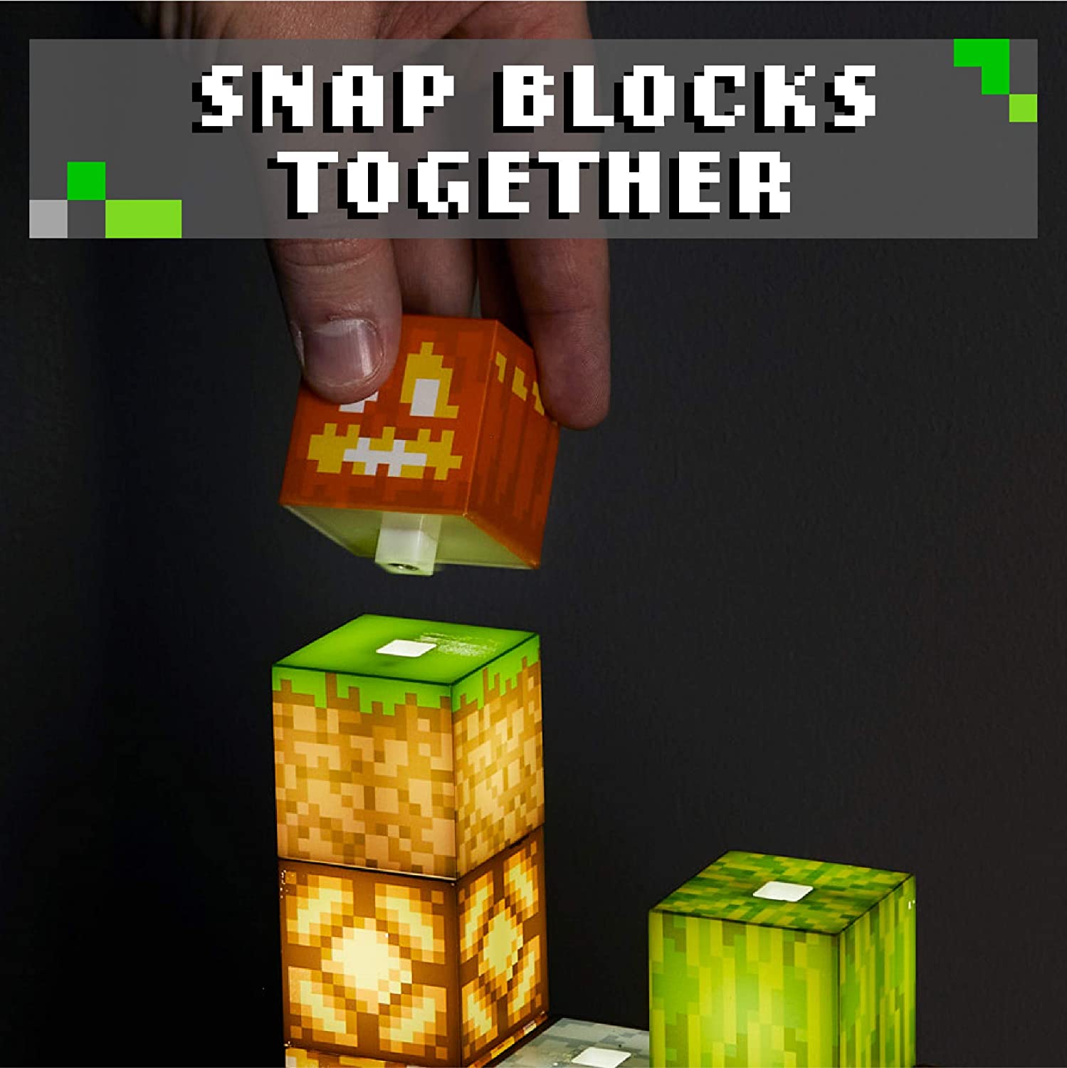 A hand is adding a block to the top of a Minecraft block building light. The text reads, 'Snap blocks together.'