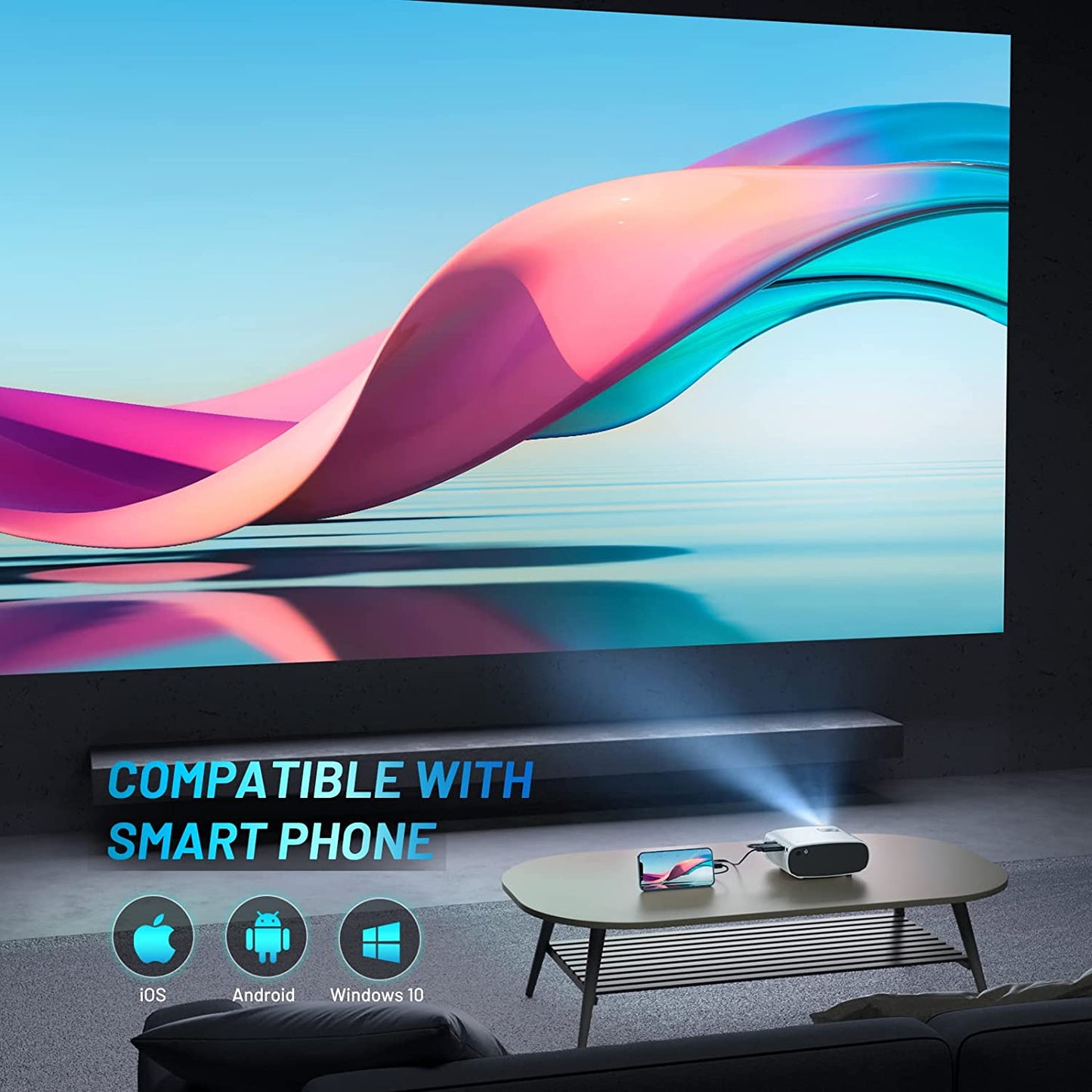 A large screen is projected onto a wall by a small mini portable projector. The text reads, 'Compatible with smart phone, iOS, Android, windows 10.'