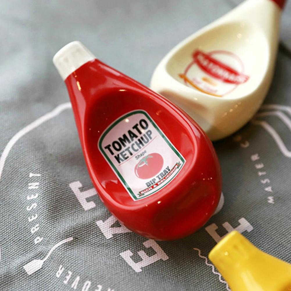A close-up of a sauce dipping bowl which looks like a miniature version of tomato ketchup. It’s used to holding dipping sauces. 