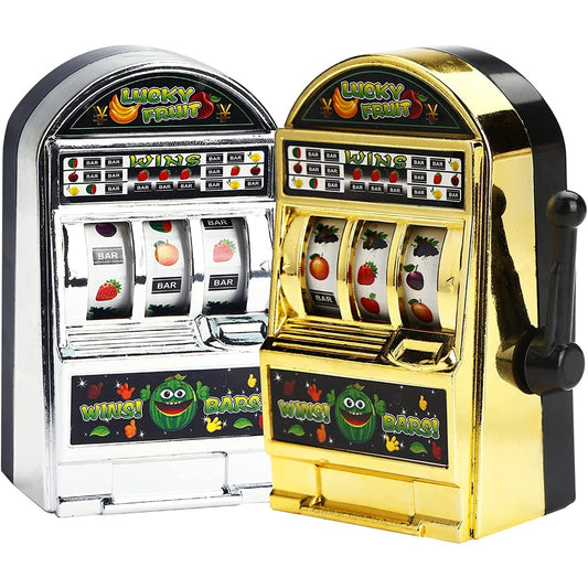 Two mini slot machine toys one colored silver the other black. These look like real mini slot machines which actually spin and work.