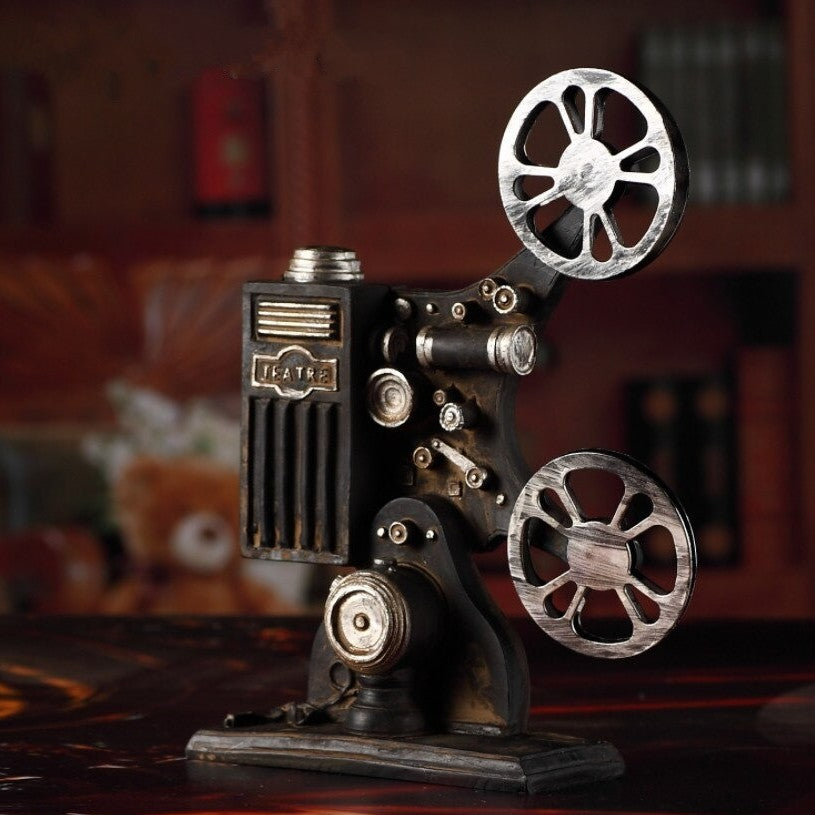 A retro miniature film projector model complete with scuff marks and old rust.