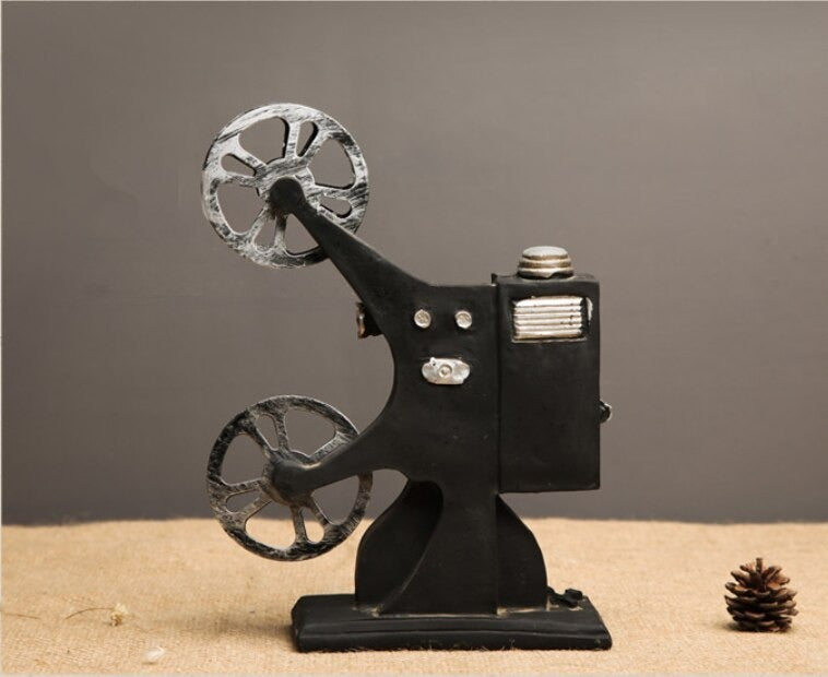 A back view of an old school miniature film projector model.