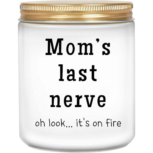 A funny white candle in a jar. On the outside of the candle printed on the jar it says, 'Moms last nerve, oh look... its on fire.'