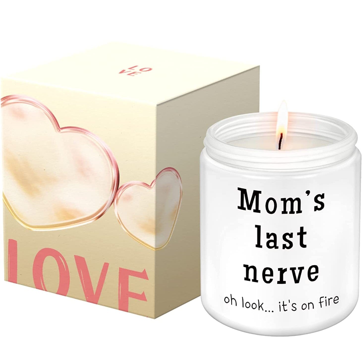 A white soy candle in a jar which says, 'Moms last nerve, oh look... its on fire.' The box for the candle is next to the candle itself.