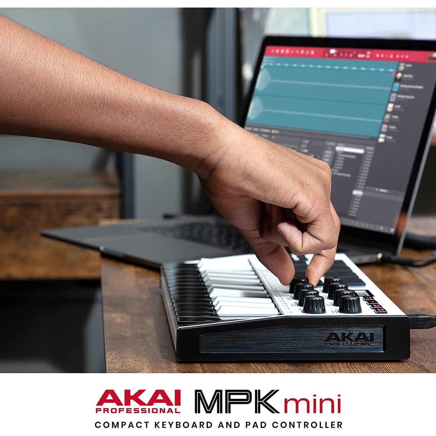 A hand is fine tuning an AKAI MPK Mini MK3.