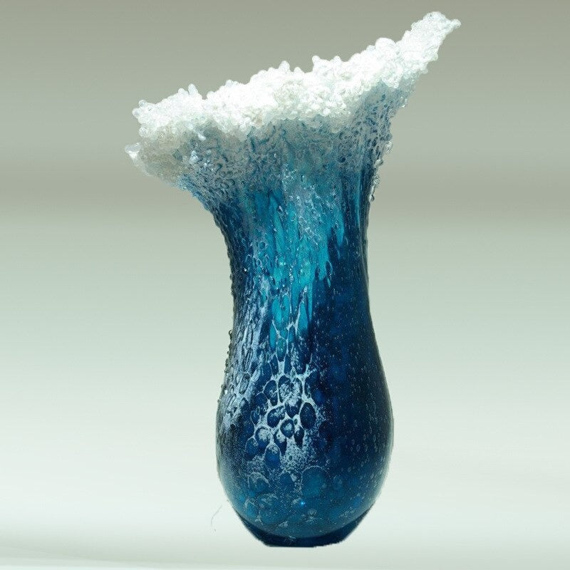 A blue and white vase which looks like an ocean wave.