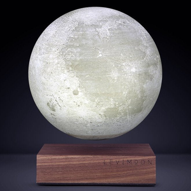 Levitating moon lamp floating above a wooden base