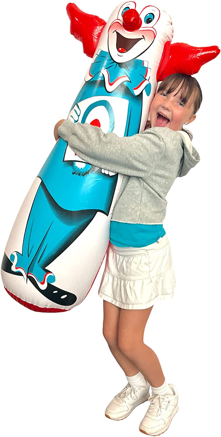A girl is hugging a Bozo the clown bop bag.
