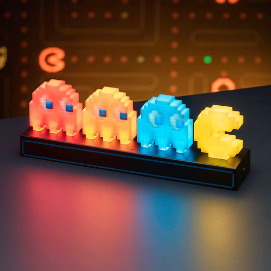 A retro-style light featuring Pac-Man with three ghosts chasing him. The light is switched on and features the colors, red, orange and blue for the ghosts and yellow for Pac-Man.