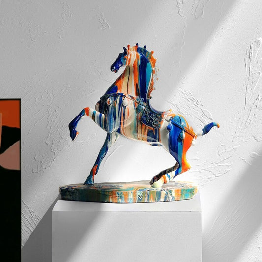 A horse figurine which looks like a can of colorful paint has been thrown on it.