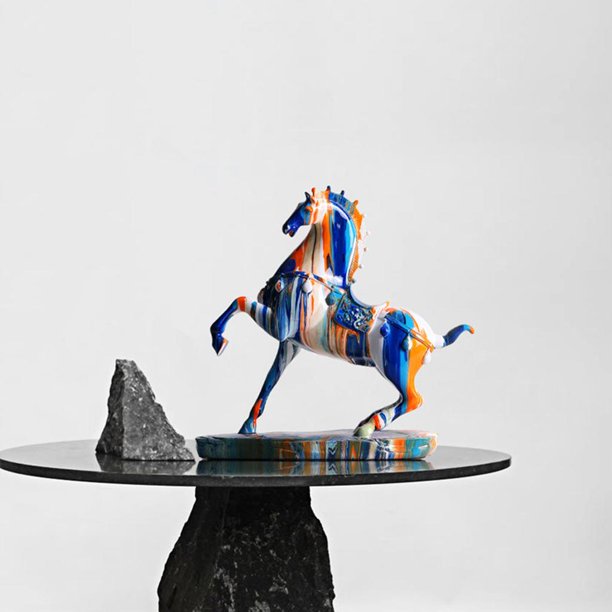 A galloping horse figurine on a glass table. The horse has been designed so it looks like colored paint is dripping down all over it.