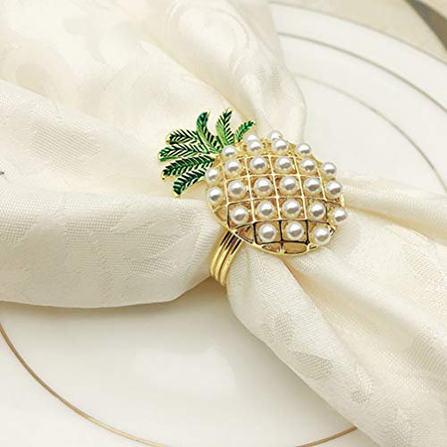 A napkin being held by a pineapple shaped napkin ring holder on a plate