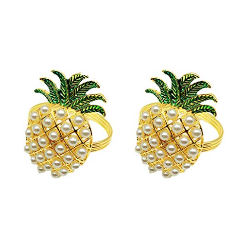 Two pineapple shaped napkin ring holders on a white background