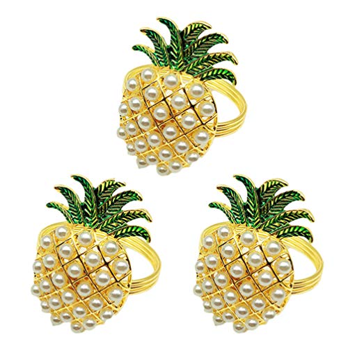 Three pineapple shaped napkin ring holders on a white background