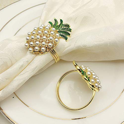 Two pineapple shaped napkin ring holders on a plate