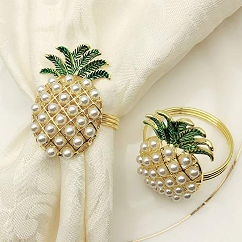 Two gold pineapple style napkin ring holders