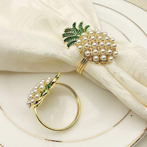 Two napkin ring holders shaped as pineapples with pearls on them