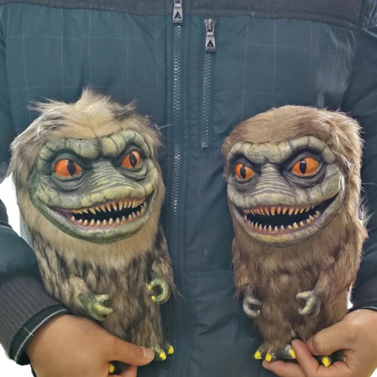 A person holding two critter dolls from the Critters movies
