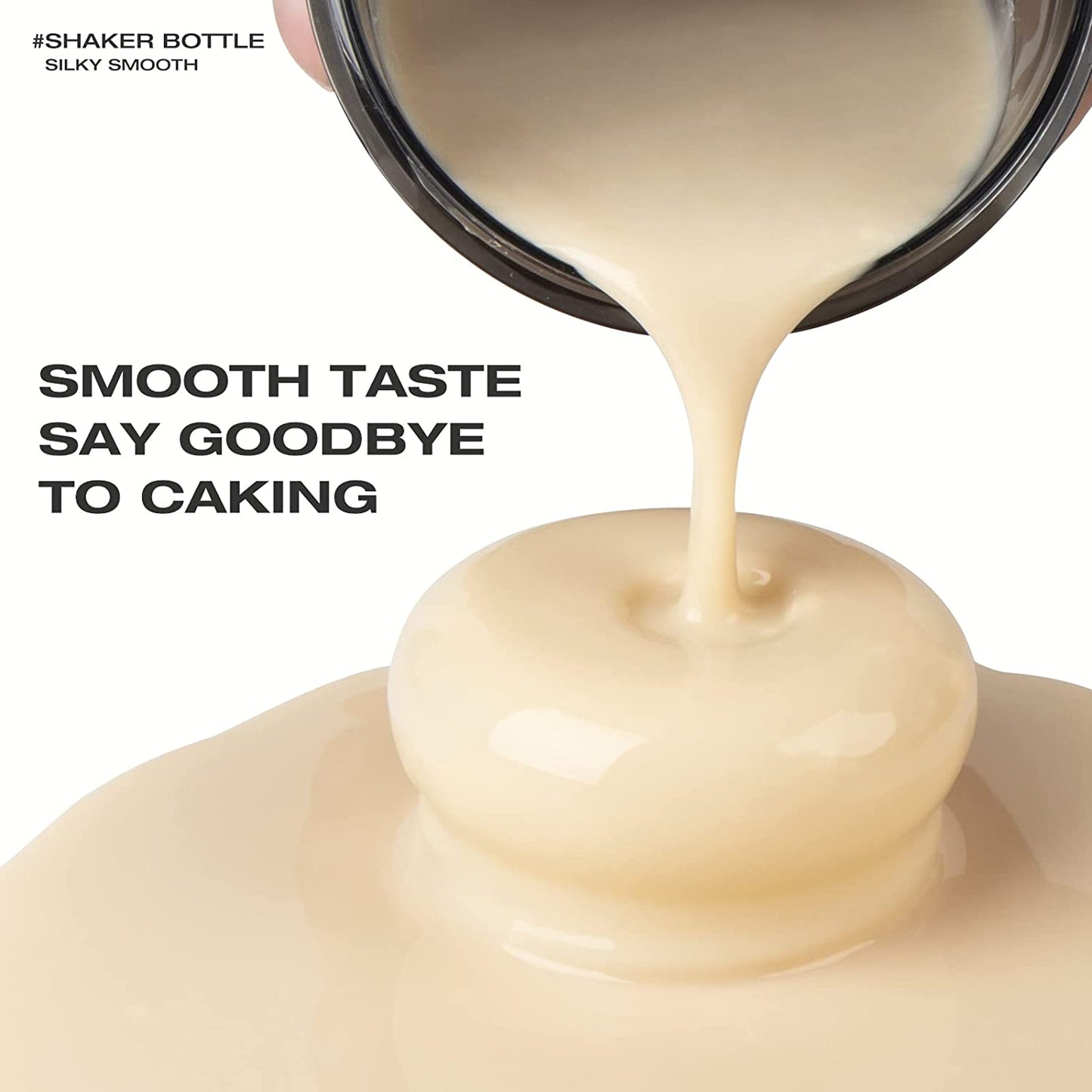 A protein shaker bottle pouring a ready made, smooth protein shake onto a white surface. There is text which reads "Smooth taste say goodbye to caking"