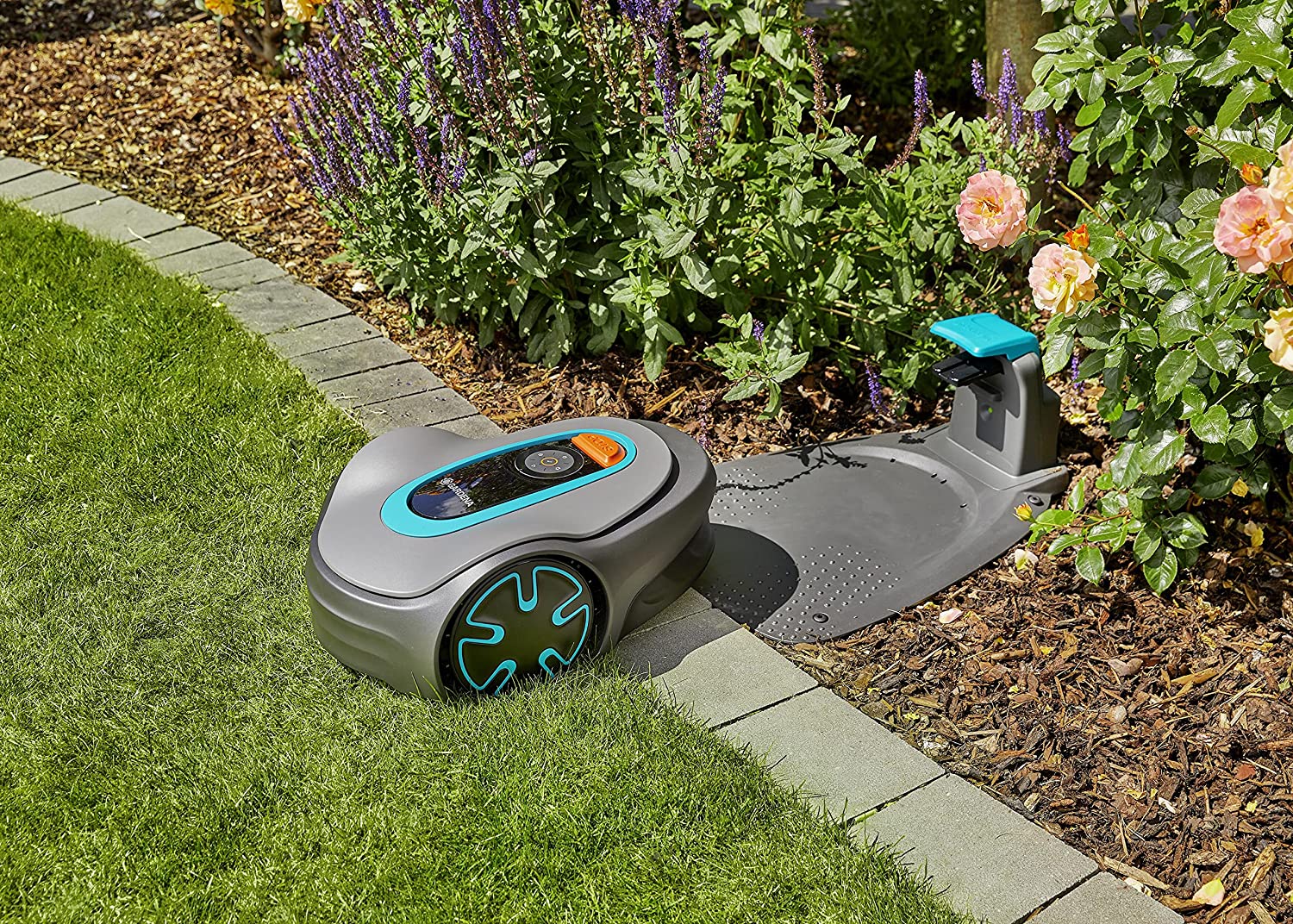 A robotic lawn mover and its docking station outside in the yard.