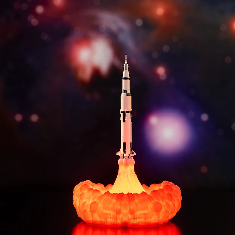 A thin rocket ship night light. The rocket appears to be blasting off into outer space with the bellowing smoke as a light.
