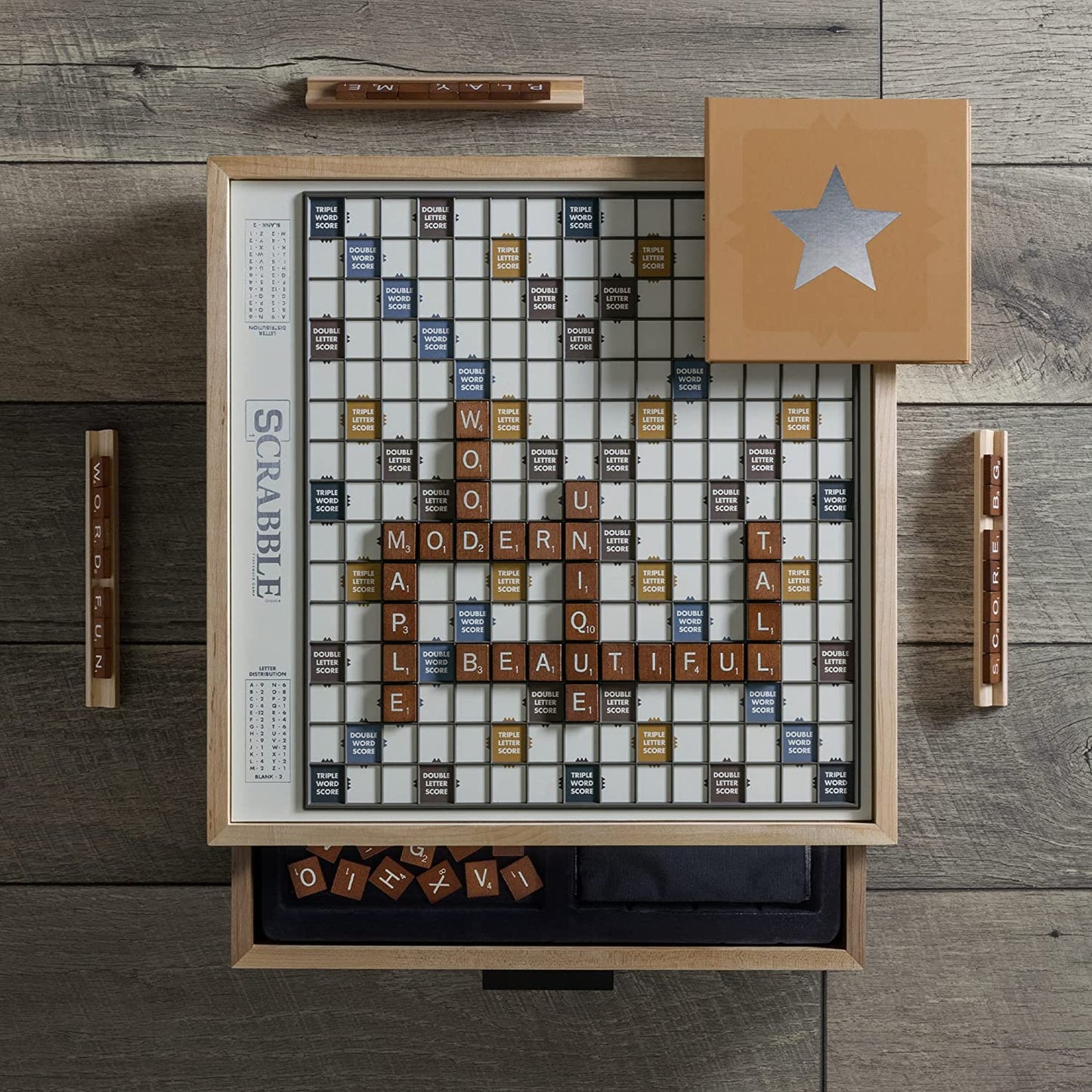 A maple wood luxury edition of Scrabble with game letter tiles on the board and in the drawers.