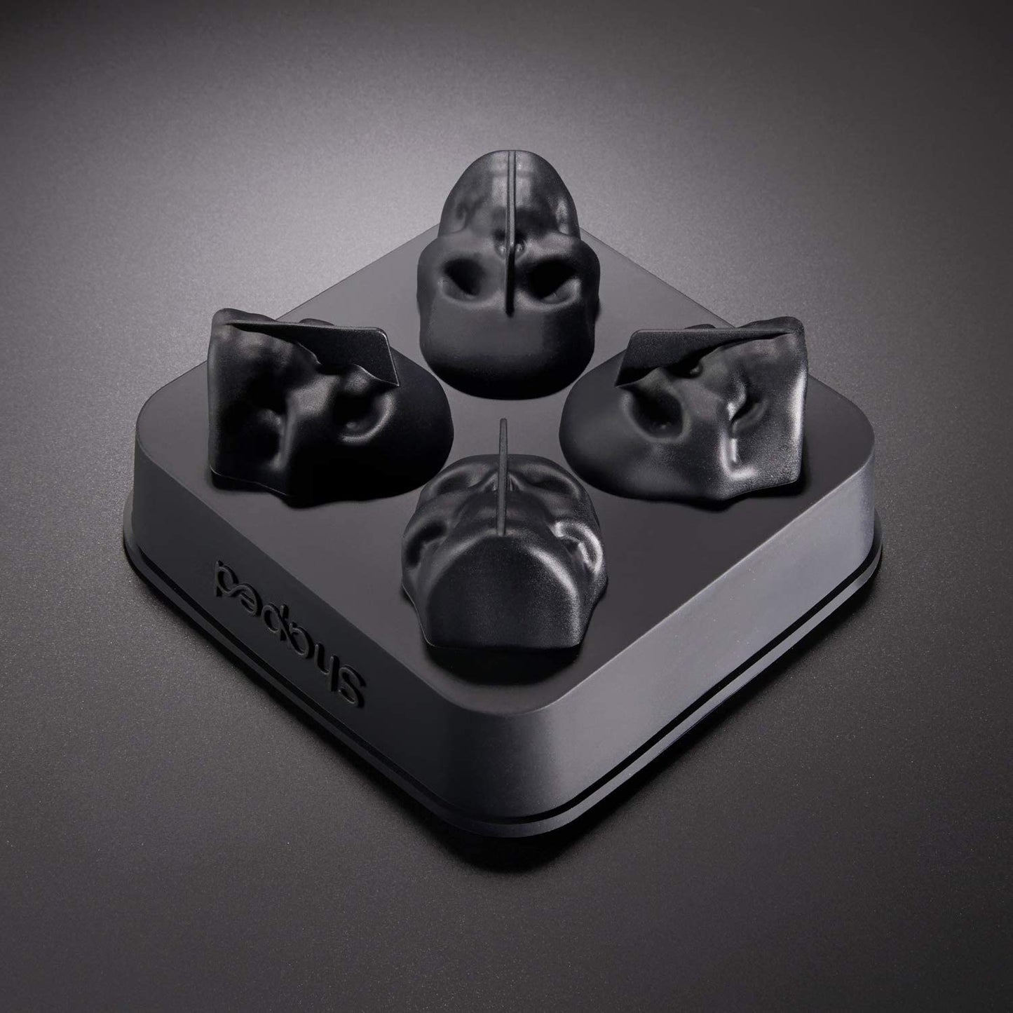 An upturned silicone ice cube mold tray showing the underside of the tray and the 4 skull shaped molds