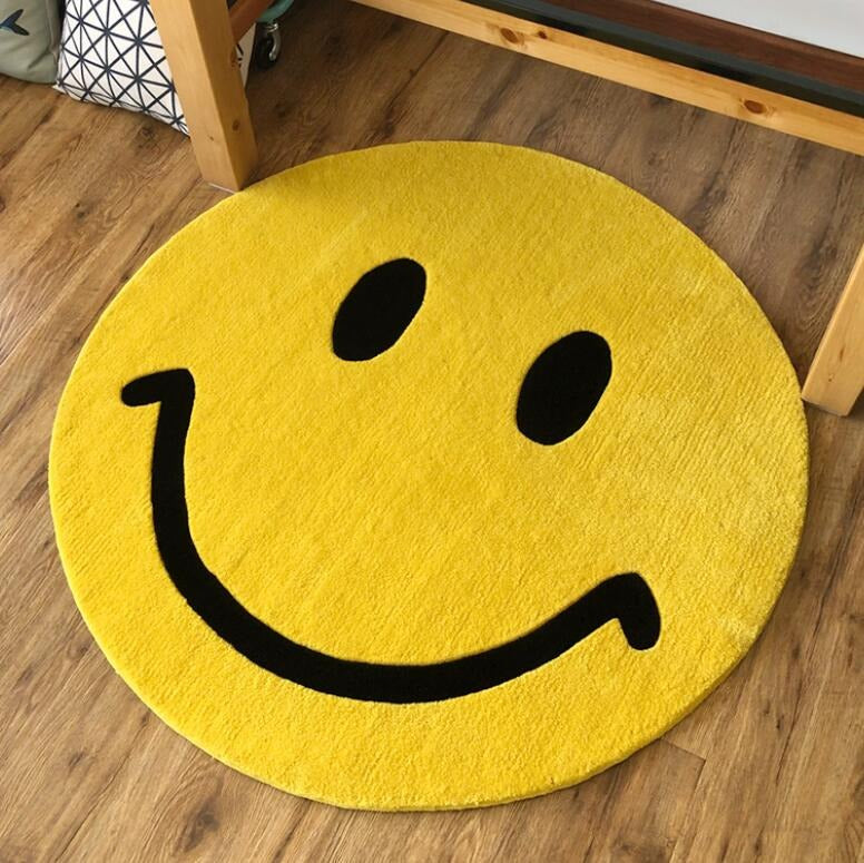 A yellow smiley emoji face which has been made into a rug.