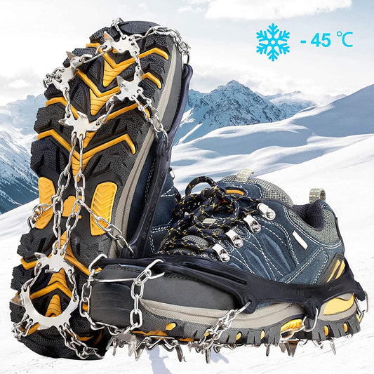 A pair of tough looking shoes with a pair of crampons attached to the base of them.