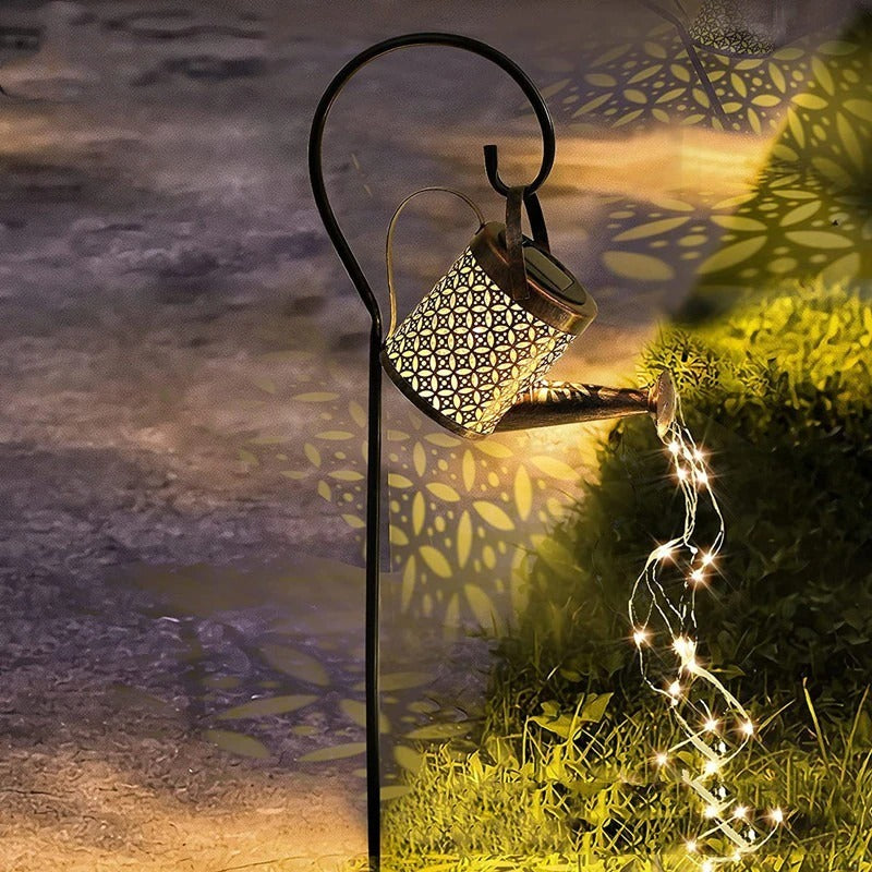 Small solar powered watering can with fairy lights coming out of the spout