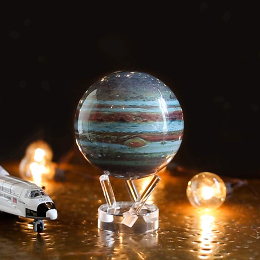 A miniature version of planet Jupiter on a clear acrylic stand