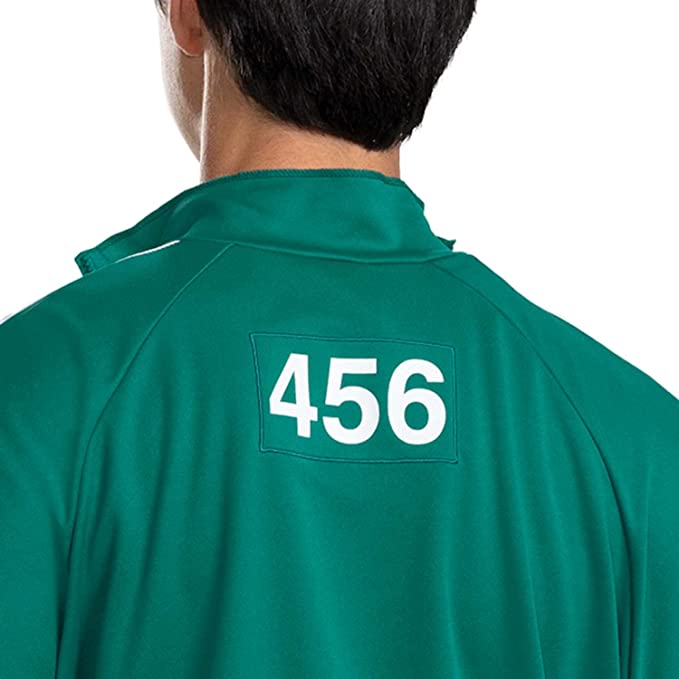 The back of a man wearing a green Squid Game Player 456 adult track suit jacket top.