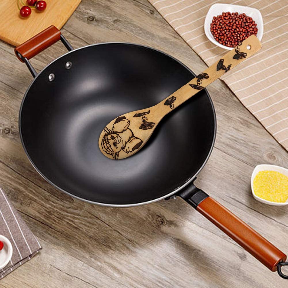 A wooden kitchen spoon featuring an image of Yoda and 5 Star Wars fighter planes. The spoon is resting inside a wok.