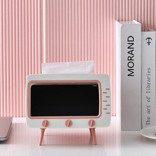 A pink and white tissue box which is shaped like a television 
