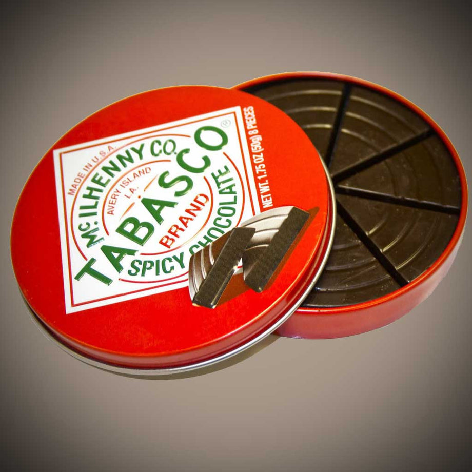 Round red Tabasco spicy dark chocolate tin opened to reveal individually portioned dark chocolate pieces